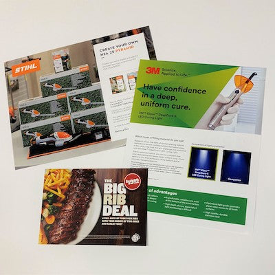 A group of brochures and forms layed out together.