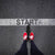 Image of feet wearing red shoes standing at a line on the ground that says Start.